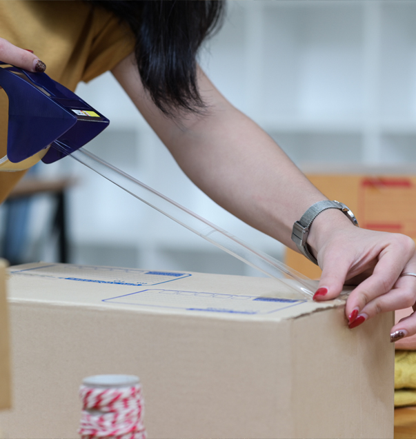 Lady packaging stuff for fast shipping